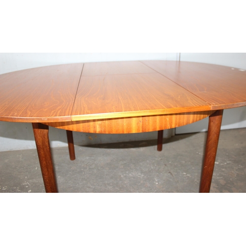 7 - A.H. McIntosh of Kirkcaldy, a retro extending dining table, approx 115cm wide x 115cm deep x 76cm ta... 