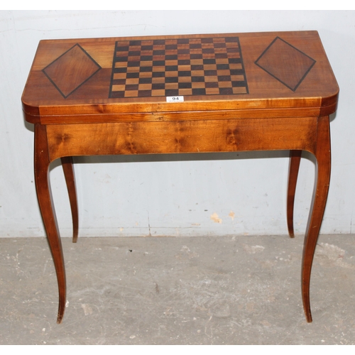 94 - A vintage inlaid wooden games and card table with fold over top, the top inlaid with chessboard styl... 