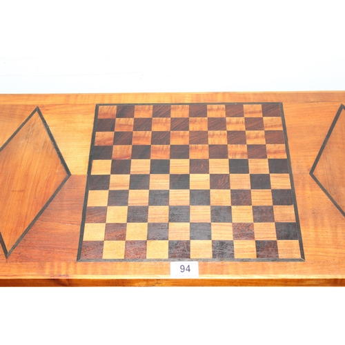 94 - A vintage inlaid wooden games and card table with fold over top, the top inlaid with chessboard styl... 