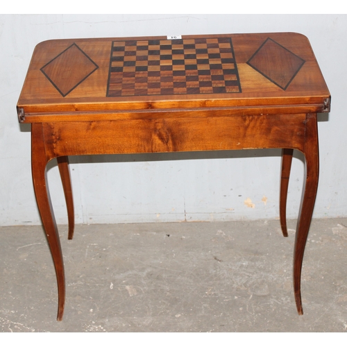 94 - A vintage inlaid wooden games and card table with fold over top, the top inlaid with chessboard styl... 