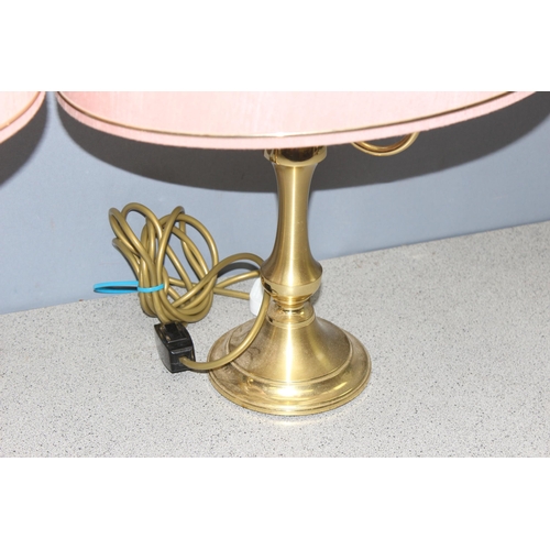 242 - Pair of dual-light brass table lamps with pink shades, approx 55cm