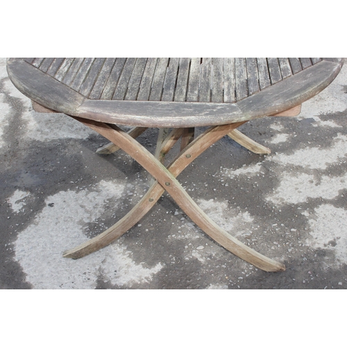 366 - A circular teak garden table and 2 directors style chairs, approx 108cm wide x 108cm deep x 74cm tal... 