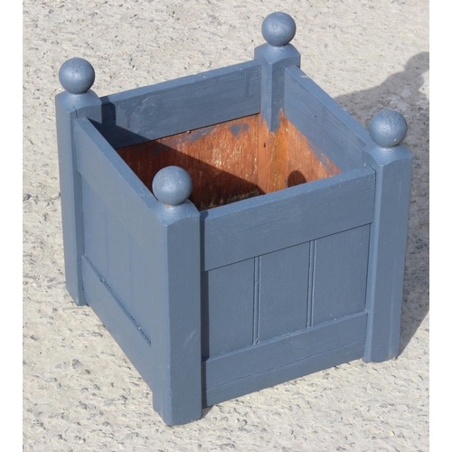 383 - A small painted wooden garden table and a pair of wooden garden planters, table approx 50cm wide x 5... 