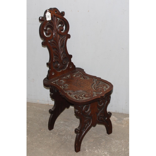 92 - A highly decorative 19th century carved oak hall chair, approx 35cm wide x 49cm deep x 87cm tall