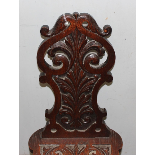 92 - A highly decorative 19th century carved oak hall chair, approx 35cm wide x 49cm deep x 87cm tall