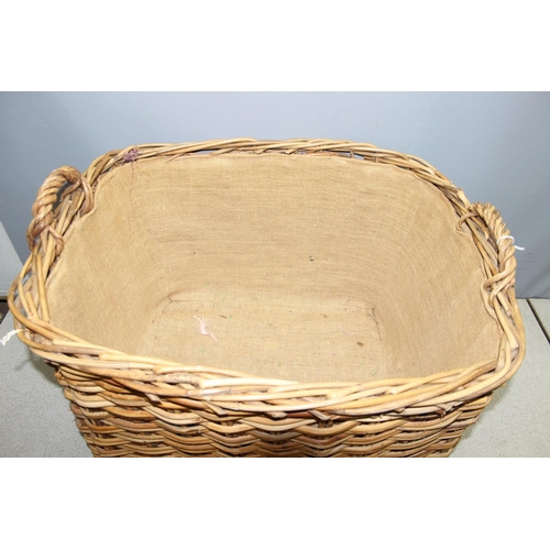 291 - Large wicker log/laundry basket with handles, approx 77cm x 67 x 52cm