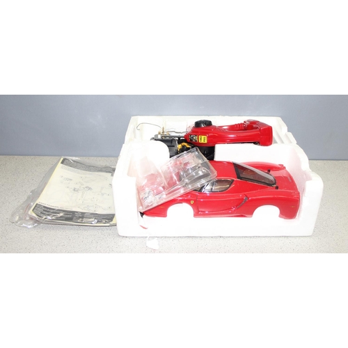 1554 - Nikko 1:14 scale Ferrari 10 piece R/c kit car with some original packaging and assorted remote contr... 