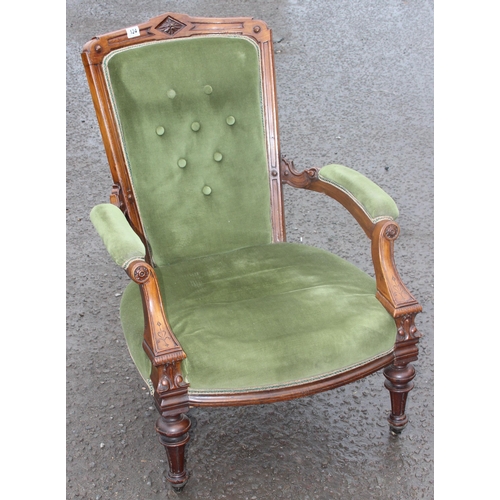 124 - A 19th century button back low chair with mahogany show frame and green upholstery