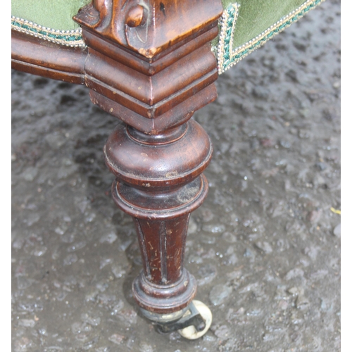 124 - A 19th century button back low chair with mahogany show frame and green upholstery