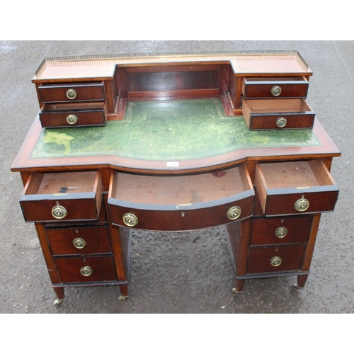 126 - An antique Carlton House style mahogany desk with tooled leather top and brass handles, approx 114cm... 