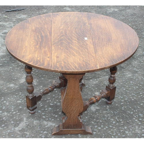 134 - A small oak drop leaf table with circular top and an Art Deco side table with glass top, largest app... 