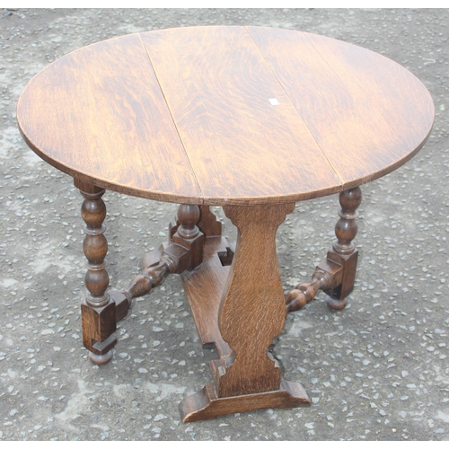 134 - A small oak drop leaf table with circular top and an Art Deco side table with glass top, largest app... 