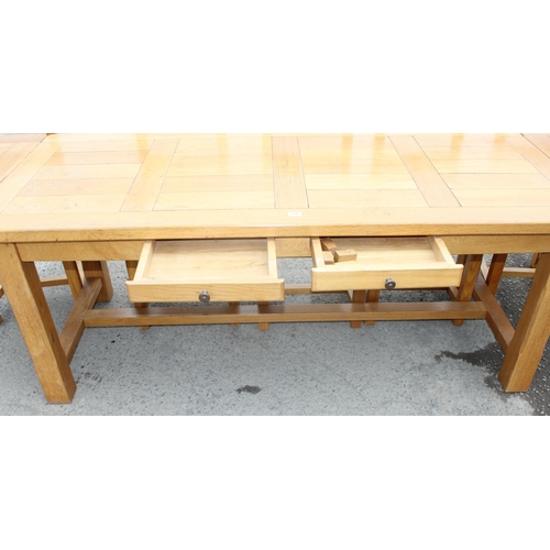 136 - Large light oak dining or refectory table with 2 drawers and 2 extending leaves and a set of 6 light... 