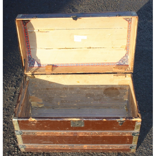 153 - An antique dome topped shipping trunk with wooden slats, some vintage labels, approx 76cm wide x 42c... 