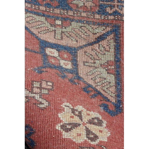 211 - A long vintage hall runner rug of red ground, probably Turkish, approx 95cm wide x 370cm long