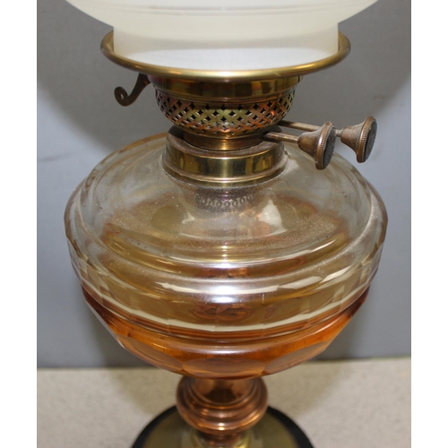 262 - Antique oil lamp with amber glass reservoir with brass and copper base, approx 64cm