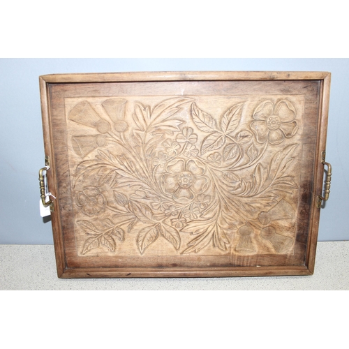 299C - An early 20th century Arts & Crafts period carved mahogany serving tray decorated with floral motifs... 