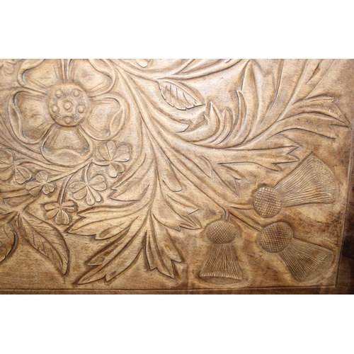 299C - An early 20th century Arts & Crafts period carved mahogany serving tray decorated with floral motifs... 