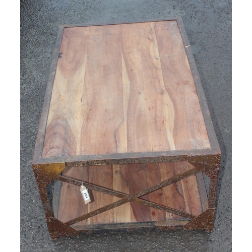 384 - An industrial style metal framed and wooden table, approx 121cm wide x 71cm deep x 46cm tall