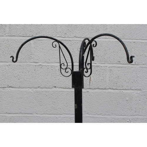 389 - A large free standing wrought iron hanging basket hanger, approx 91cm wide x 91cm deep x 177cm tall