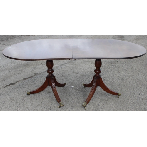 121 - An antique style mahogany twin pedestal dining table, approx 244cm wide x 103cm deep x 77cm tall