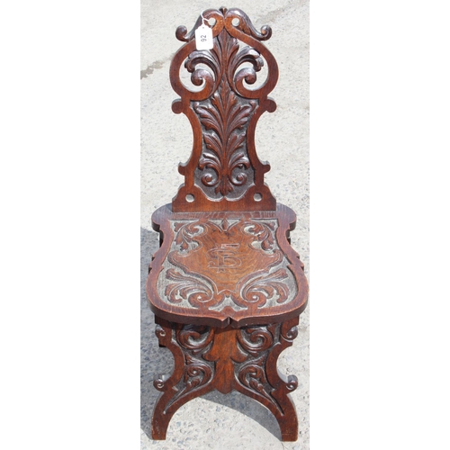 92 - A highly decorative 19th century carved oak hall chair, approx 35cm wide x 49cm deep x 87cm tall