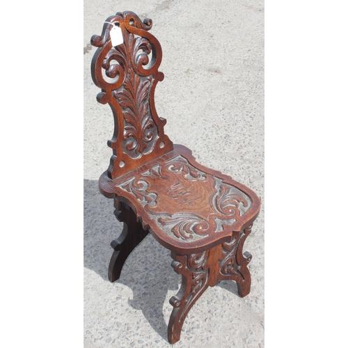 92 - A highly decorative 19th century carved oak hall chair, approx 35cm wide x 49cm deep x 87cm tall