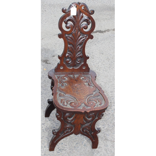 92 - A highly decorative 19th century carved oak hall chair, approx 35cm wide x 49cm deep x 87cm tall