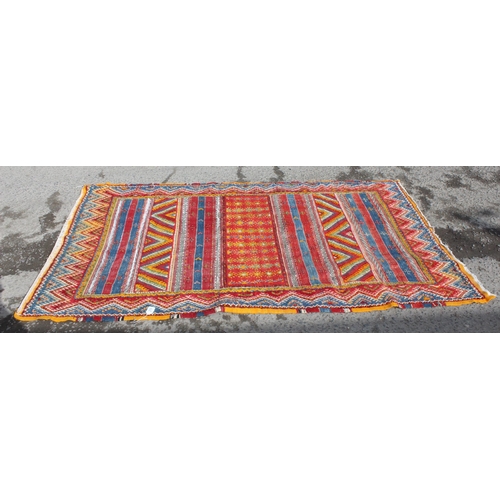 219 - An unusual vintage colourful handmade flatweave rug of yellow, red and blue ground, the rug containi... 