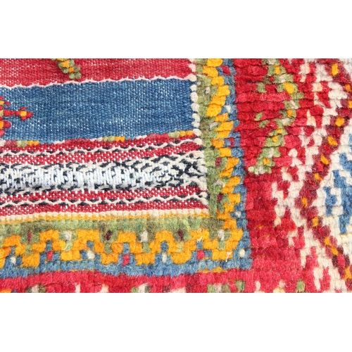 219 - An unusual vintage colourful handmade flatweave rug of yellow, red and blue ground, the rug containi... 