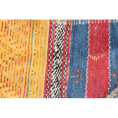 219 - An unusual vintage colourful handmade flatweave rug of yellow, red and blue ground, the rug containi... 