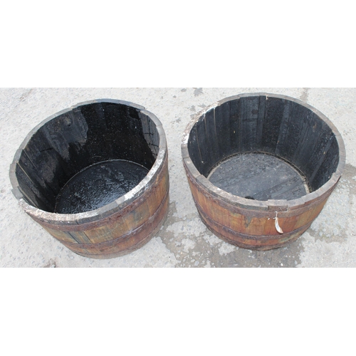 360 - A pair of wooden barrel planters, approx 64cm wide x 64cm deep x 40cm tall