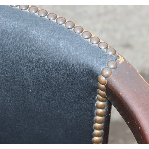 17 - A vintage oak and studded faux leather desk chair, approx 51cm wide x 51cm deep x 73cm tall