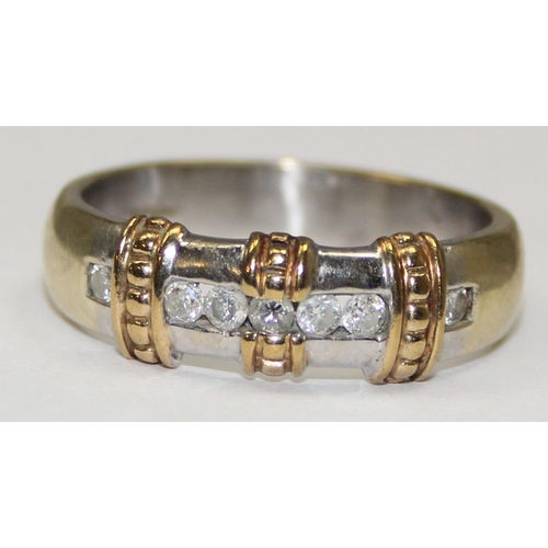 1164 - A 9ct gold retro style band ring set with 7 diamonds in a strap setting, full English hallmarks, app... 