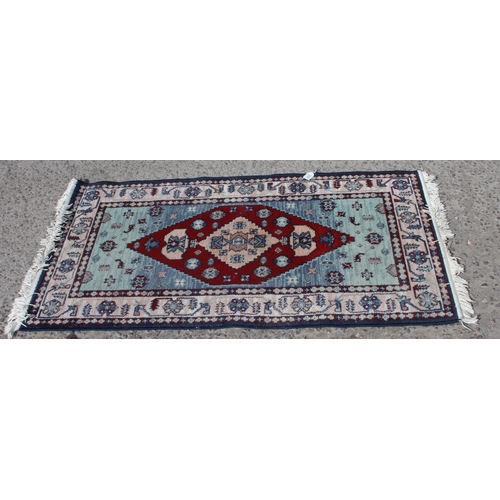 204 - Persian style blue-ground rug, approx 150cm x 80cm