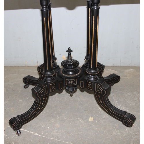 5 - A Victorian burr walnut and ebonised card or games table standing on pillar supports with blue baize... 