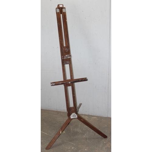 95 - A large wooden floor standing artist's easel and canvas, as photographed approx 212cm tall