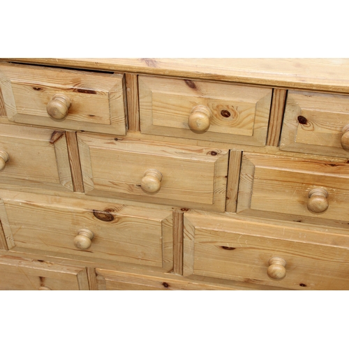 24 - An unusual modern pine 14 drawer chest of drawers, approx 126cm wide x 33cm deep x 92cm tall