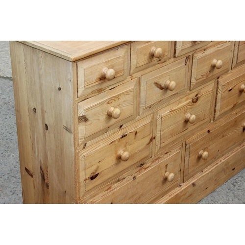 24 - An unusual modern pine 14 drawer chest of drawers, approx 126cm wide x 33cm deep x 92cm tall