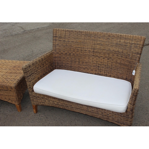 26 - A wicker conservatory 2 seater sofa and a small matching table, sofa approx 120cm wide