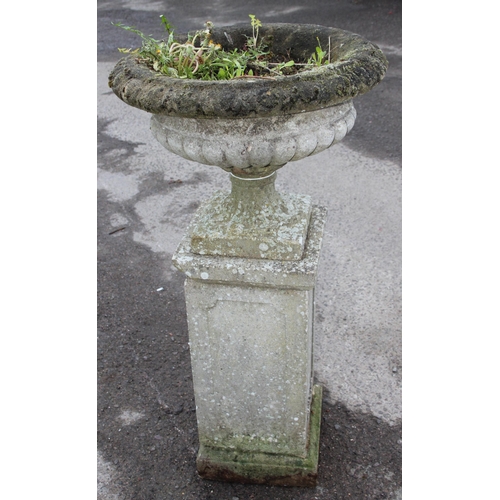 300 - A large weathered planted reconstituted stone urn on plinth, approx 56cm wide x 56cm deep x 114cm ta... 