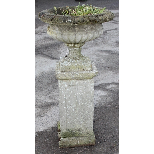 300 - A large weathered planted reconstituted stone urn on plinth, approx 56cm wide x 56cm deep x 114cm ta... 