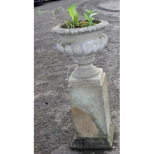 301 - A large weathered planted reconstituted stone urn on plinth, approx 41cm wide x 41cm deep x 93cm tal... 