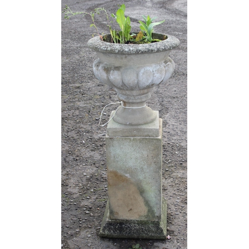 301 - A large weathered planted reconstituted stone urn on plinth, approx 41cm wide x 41cm deep x 93cm tal... 