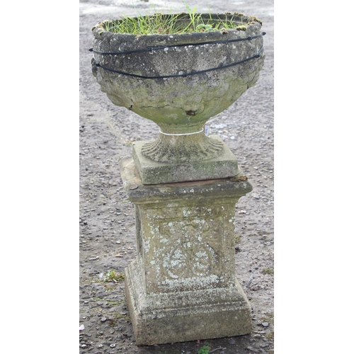 303 - A large weathered reconstituted stone urn on plinth A/F, approx 42cm wide x 42cm deep x 84cm tall