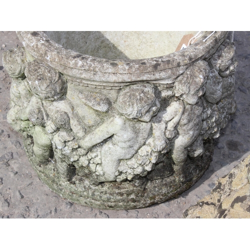 313 - 2 weathered concrete garden pots decorated with cherubs and a Buddha statue, the pots approx 27cm wi... 