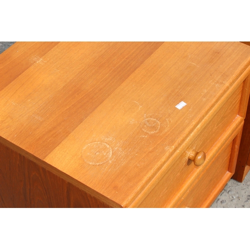 38 - A pair of mid century teak G-Plan 2 drawer bedside cabinets or end tables, approx 50cm wide x 46cm d... 