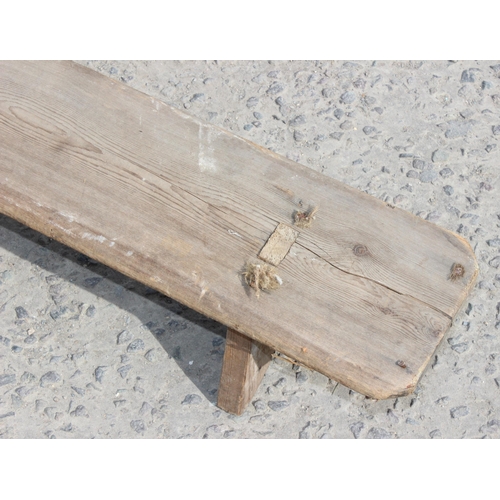 53 - An unusual vintage rustic pine long low foot rest or low bench, approx 257cm wide x 17cm deep x 20cm... 