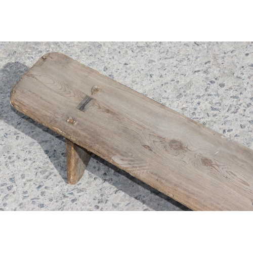 53 - An unusual vintage rustic pine long low foot rest or low bench, approx 257cm wide x 17cm deep x 20cm... 