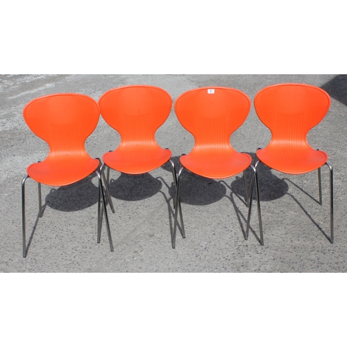 57 - A set of 4 retro style orange plastic and chrome chairs, approx 53cm wide x 51cm deep x 83cm tall